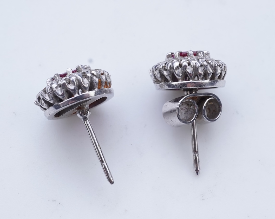 A pair of ruby and diamond earrings